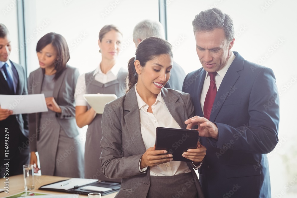 Businessman and businesswoman using digital tablet Businessman and businesswoman using digital tablet