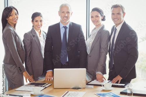 Businesspeople smiling in conference room