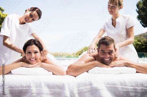 Young couple receiving a back massage from masseur © WavebreakmediaMicro