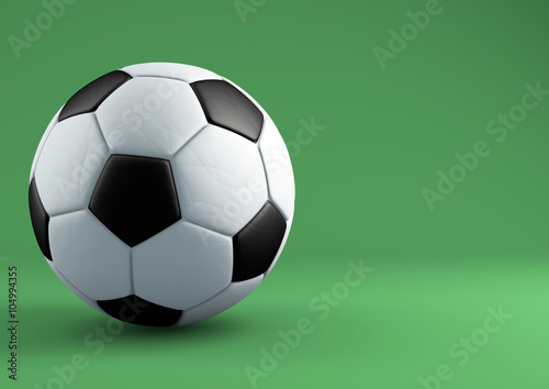 Soccer ball with shadows on green background.