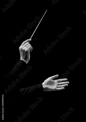 Hands of conductor on a black background in black and white