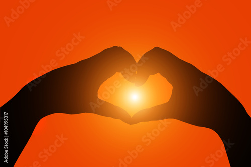 silhouette hands heart shape with sun in the middle 
