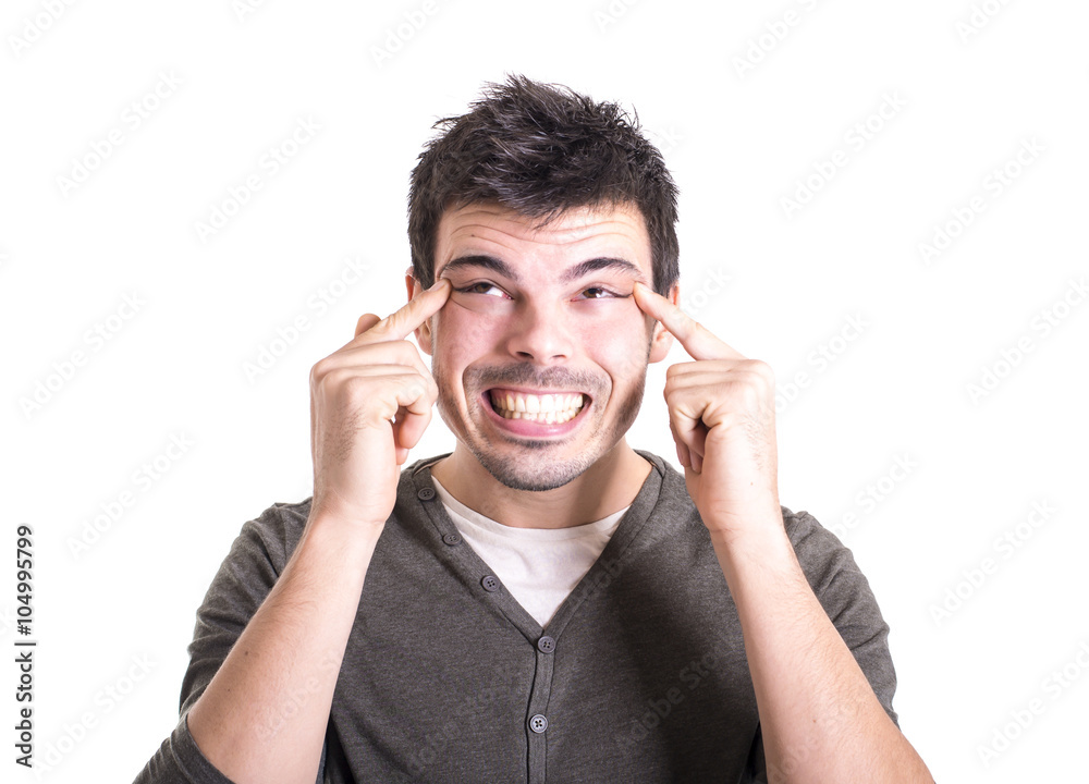 Happy young man putting his fingers on head on a white backgroun Happy young man putting his fingers on head on a white backgroun