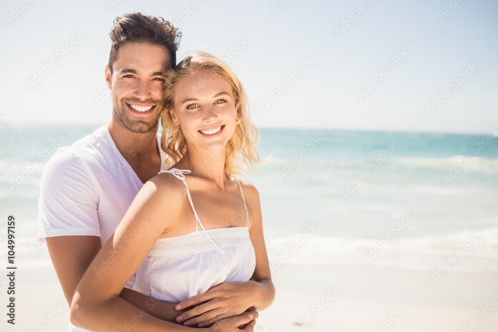 Smiling young couple hugging Smiling young couple hugging