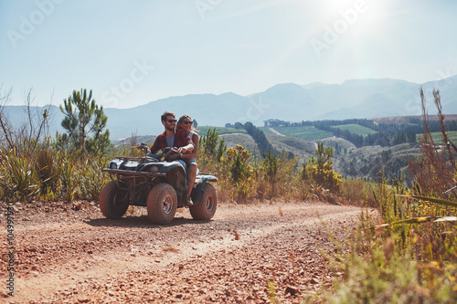 Couple on holiday enjoying on a ATV bike ride.