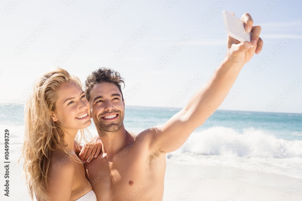 Fototapeta premium Smiling couple taking selfie