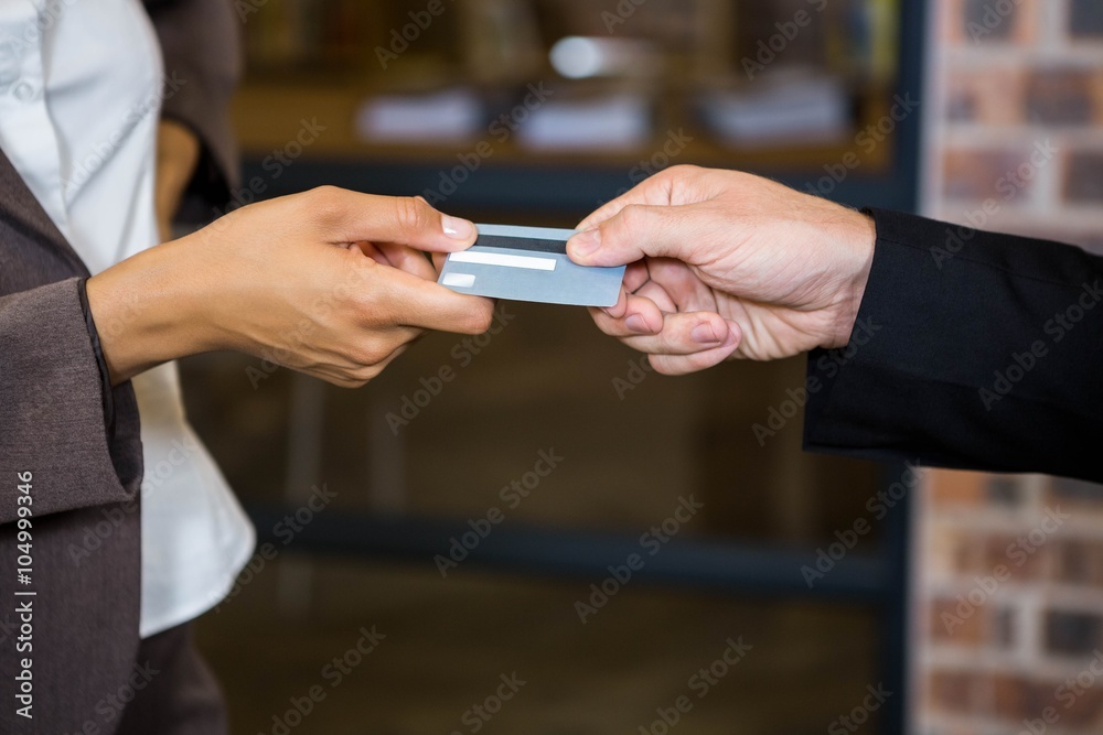 Businessman and businesswoman holding a credit card