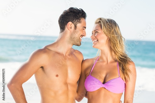 Happy couple hugging on the beach 