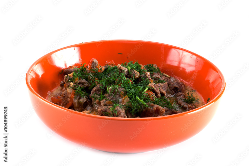 meat cooked with vegetables, parsley and dill in an orange plate meat cooked with vegetables, parsley and dill in an orange plate