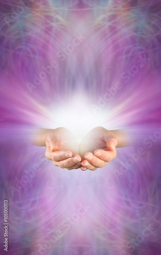 Receiving a Reiki Attunement - female cupped hands with burst of white energy above on a beautiful intricate feminine purple pink energy formation background with plenty of copy space