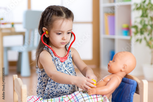 child playing doctor with d...