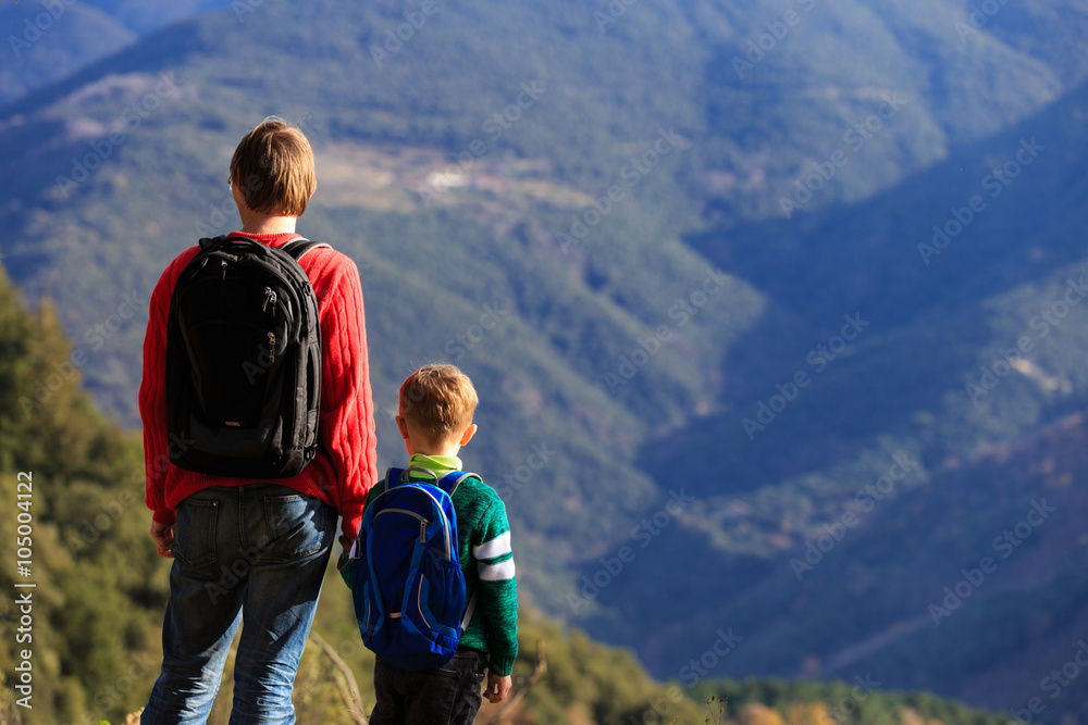 father and little son travel hiking in mountains