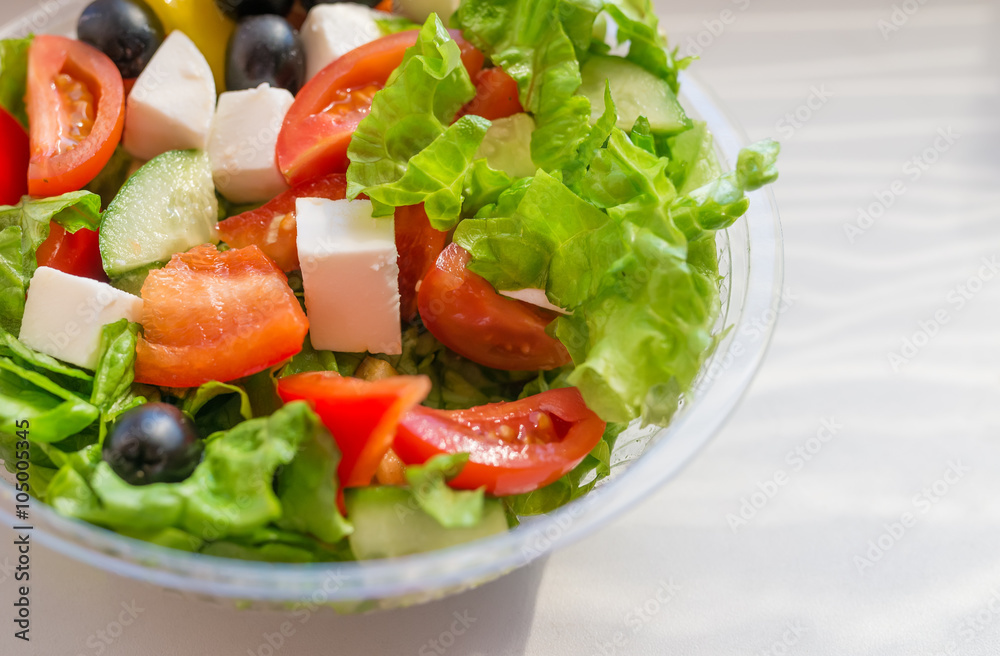 Greek salad with vegetables, cheese and olives in plastic container. Selective focus. Greek salad with vegetables, cheese and olives in plastic container. Selective focus.