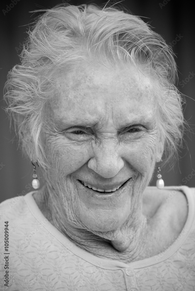 Portrait of smiling elderly lady in black and white