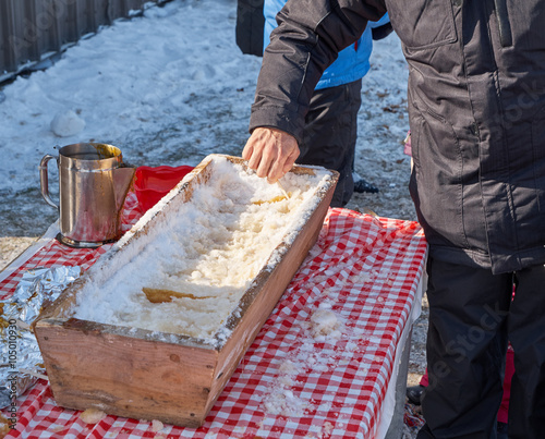 a man rolling hot maple taffy