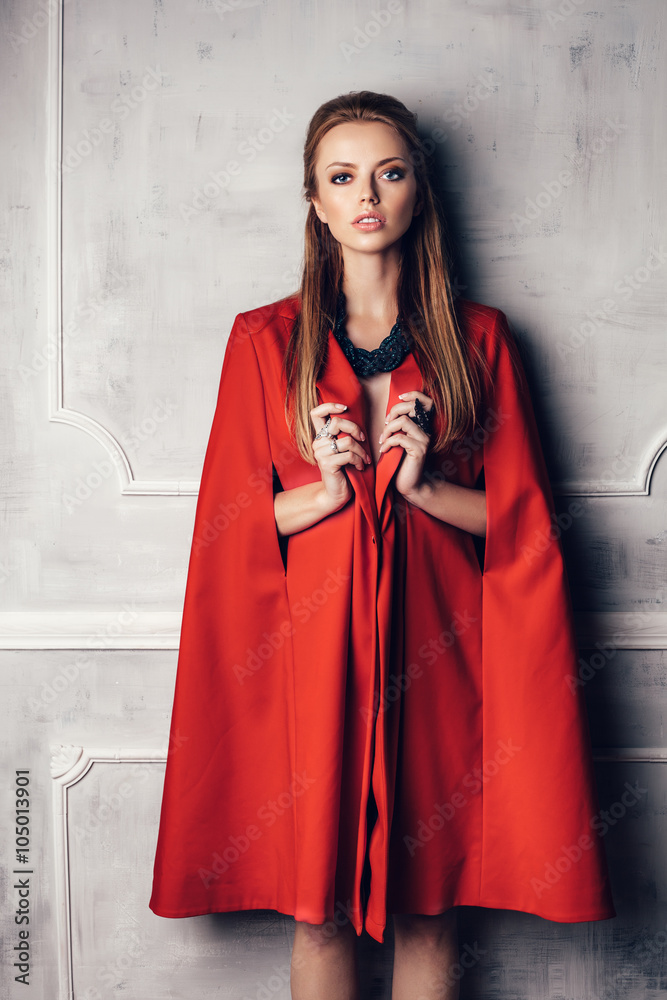 Fashion young beautiful woman in red coat