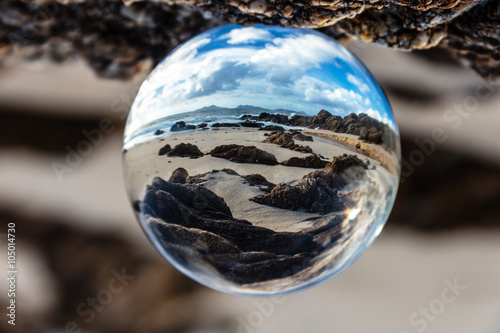 Crystal ball reflection on the beach