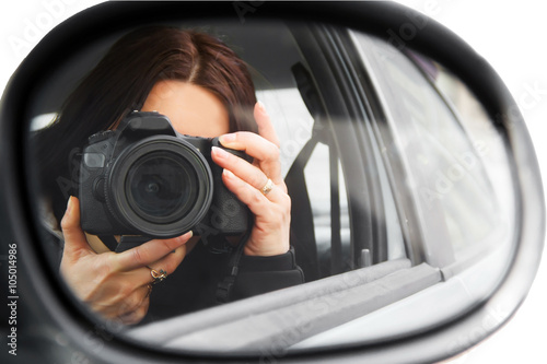 Photographer using his professional camera. Photographer girl in the car window. Mobile reporter with the DSLR camera. Photojournalist at work. Photographer on walk with a professional camera. 
