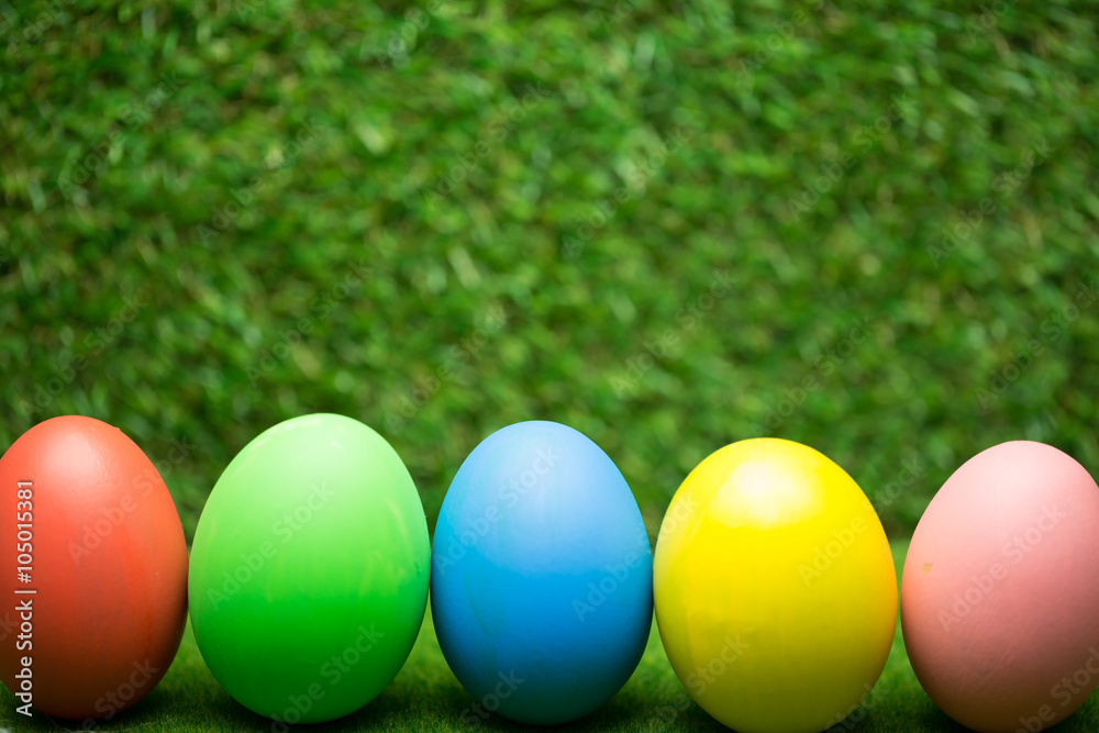Row of Easter eggs on grass