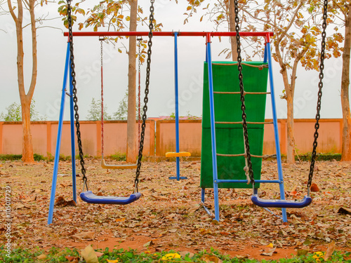 The colorful swing set in the garden.