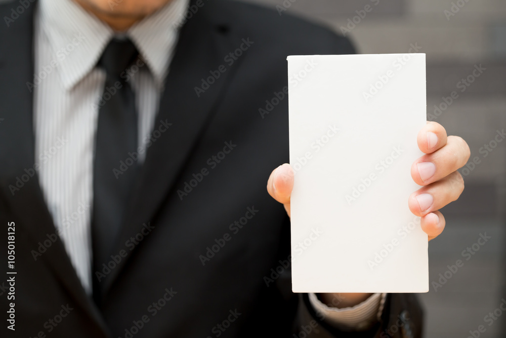 Hand of businessman showing white paper Hand of businessman showing white paper