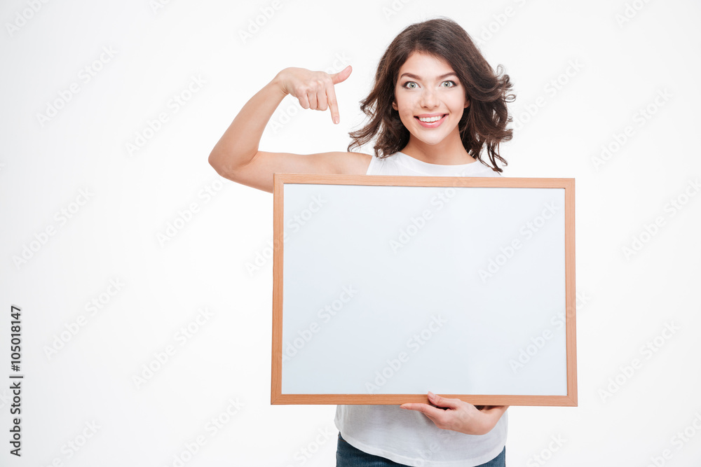 Smiling woman pointing finger on blank board Smiling woman pointing finger on blank board