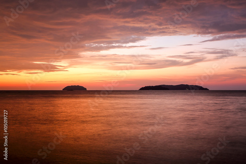 Sunset with dramatic clouds on the tropical beach while magic hour. © androver