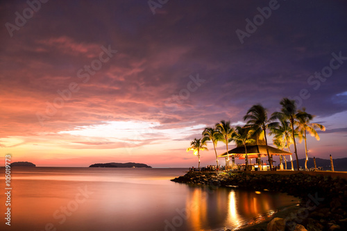 beautiful sunset with beach bar at tropical beach. Stunning long exposure sunset.