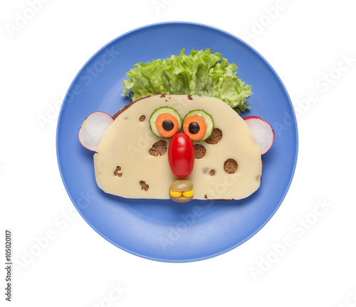 Funny face made of food on blue plate