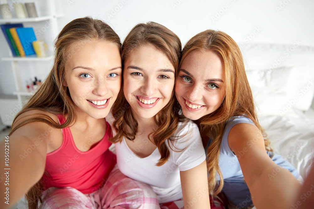 happy friends or teen girls taking selfie at home happy friends or teen girls taking selfie at home