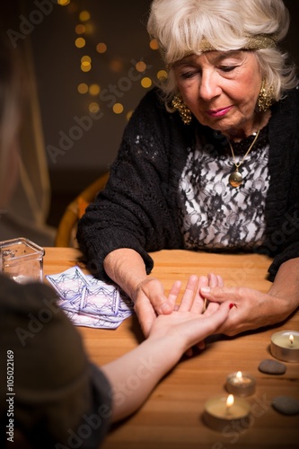 Фотография Fortuneteller reading somebody's palm