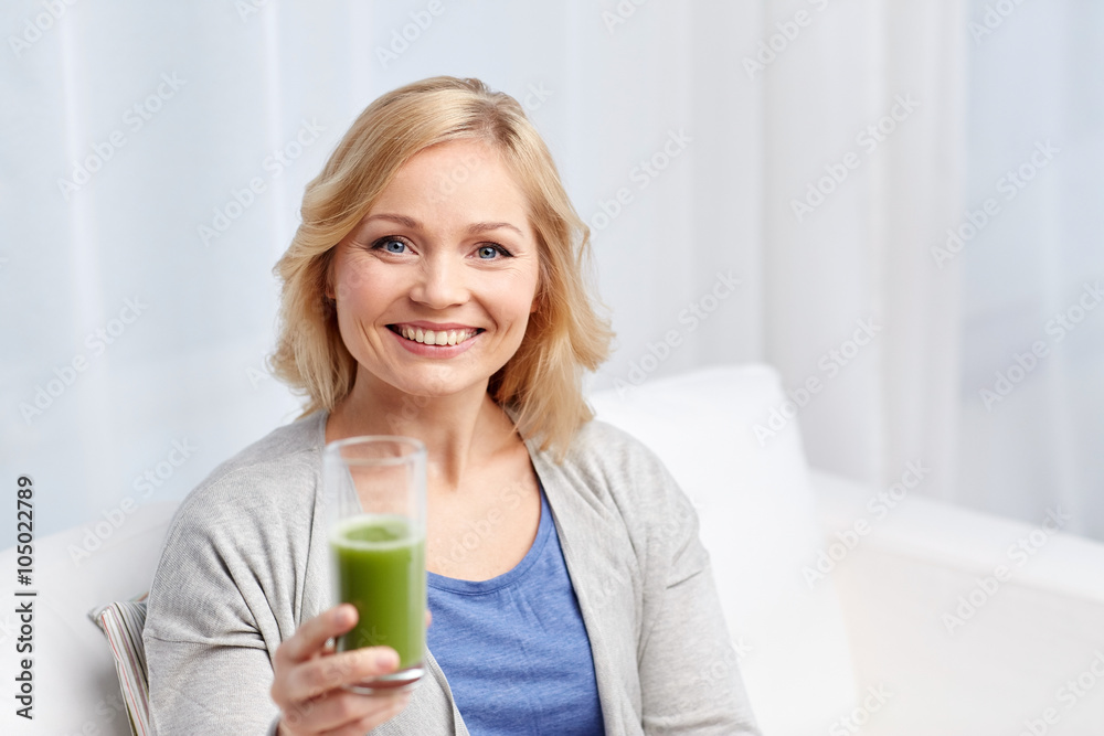 happy woman drinking green juice or shake at home happy woman drinking green juice or shake at home