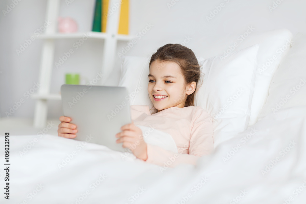 happy girl lying in bed with tablet pc at home happy girl lying in bed with tablet pc at home