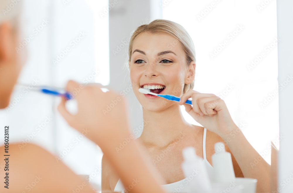 woman with toothbrush cleaning teeth at bathroom woman with toothbrush cleaning teeth at bathroom