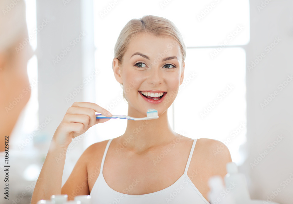 woman with toothbrush cleaning teeth at bathroom woman with toothbrush cleaning teeth at bathroom