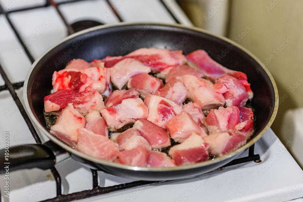 Raw pork on frying pan Raw pork on frying pan