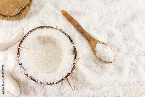 Halved fresh coconut and coconut powder