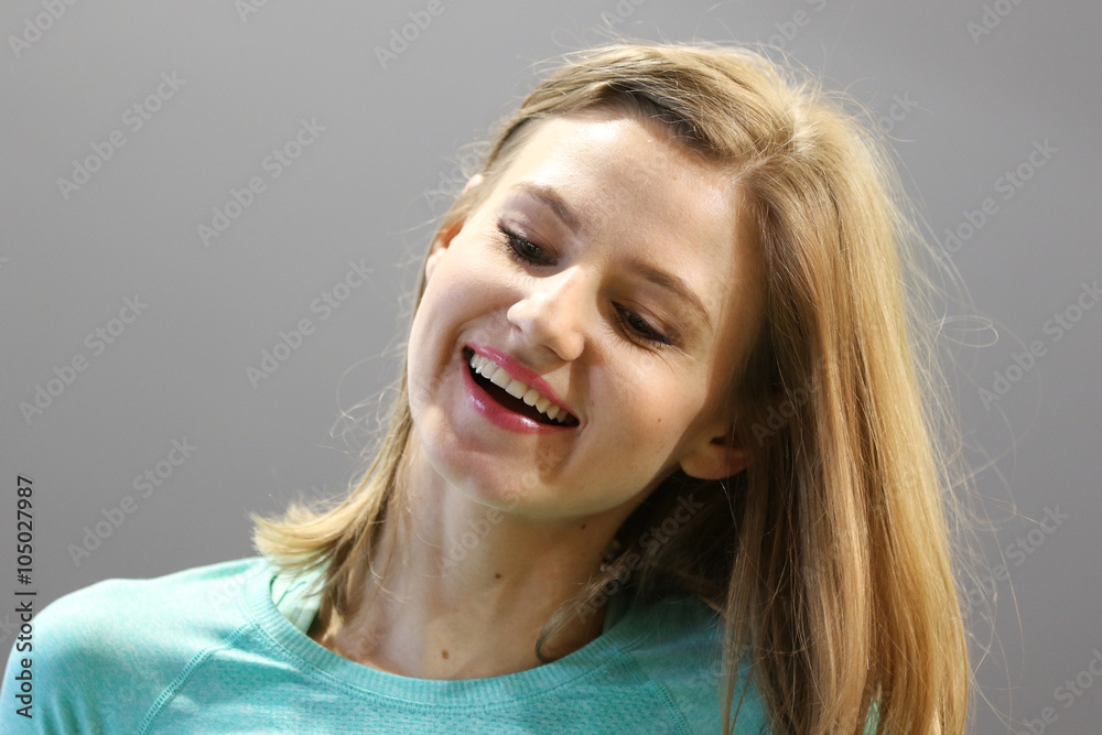 Fototapeta premium Young smiling woman with long blonde hair