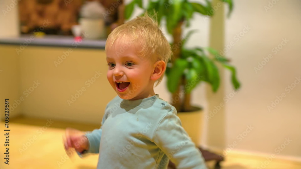 Happy boy is running around the living room
