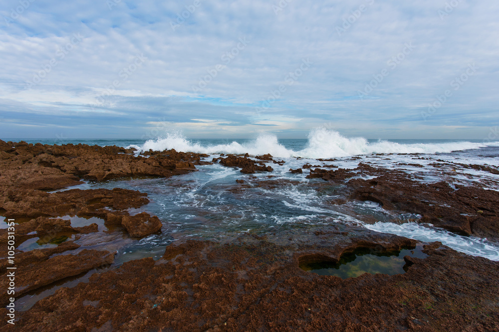 Waves breaking on a rocky seashore at the Atlantic ocean