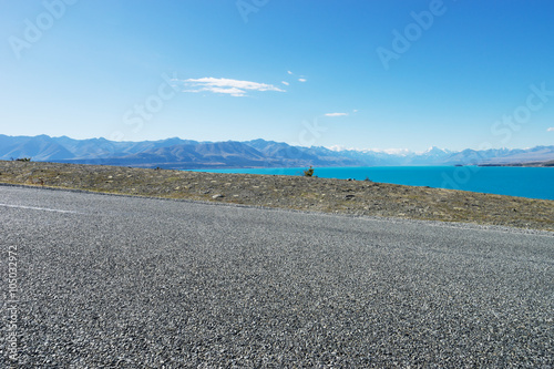 asphalt road near lake in summer day in New Zealand