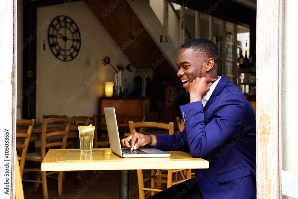 Businessman working on laptop in cafe