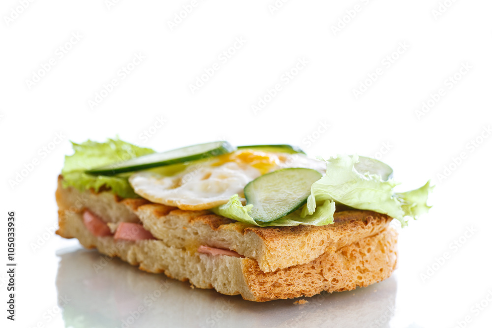 sandwich with sausage, cheese, lettuce and eggs