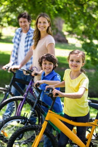 Smiling family with their bikes © WavebreakmediaMicro