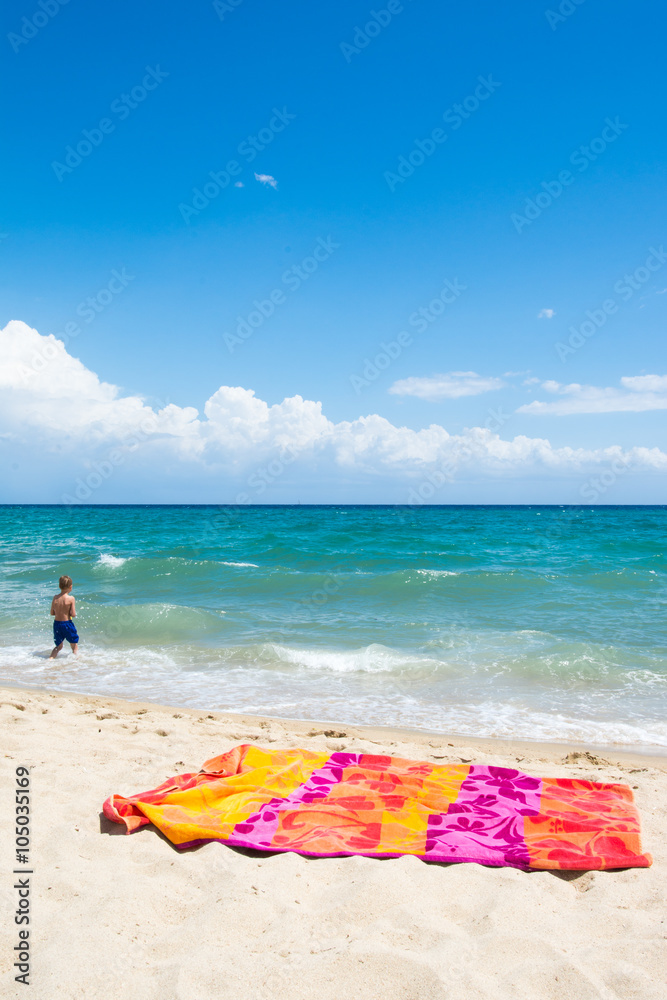 Little child walking on the beach, beach vacation