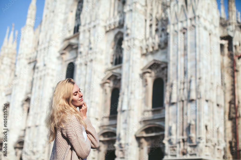 blonde girl on the background of the Duomo in Milan