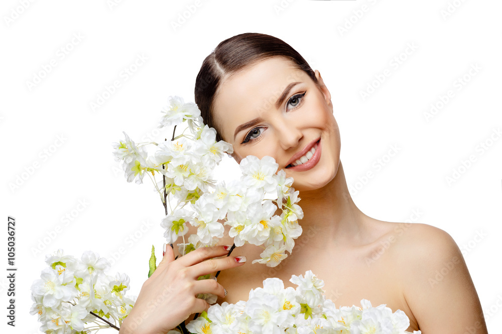 Beautiful Woman with Clean Fresh Skin holding flowering branches
