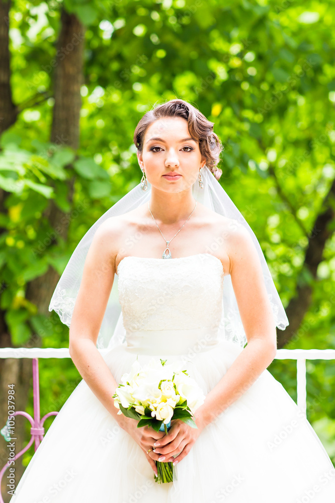 Beautiful bride girl in wedding dress with bouquet of flowers, outdoors portrait Beautiful bride girl in wedding dress with bouquet of flowers, outdoors portrait