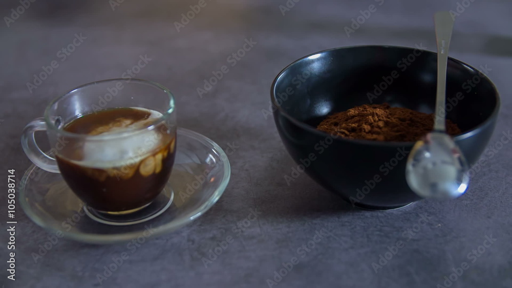 Putting milk in a cup of coffee