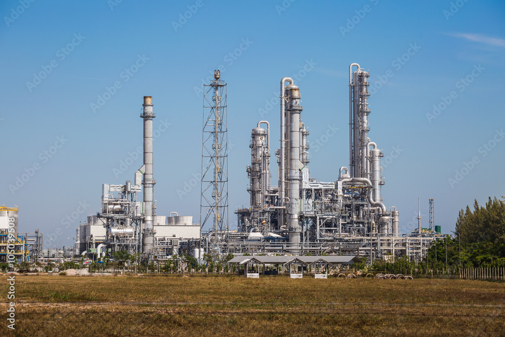 Refinery tower fo oil and refinery plant with blue sky - Landscape view Refinery tower fo oil and refinery plant with blue sky - Landscape view